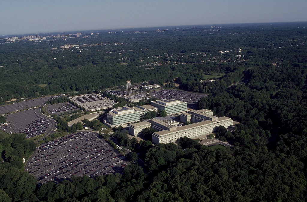 <i>CIA Headquarters Langley, Virginia, Image Source: <a href='https://www.google.com/url?sa=i&source=images&cd=&cad=rja&uact=8&ved=2ahUKEwiV8ICbvpHiAhUSna0KHctwCnQQjhx6BAgBEAM&url=https%3A%2F%2Fcommons.wikimedia.org%2Fwiki%2FFile%3AAerial_view_of_CIA_headquarters%2C_Langley%2C_Virginia_14762v.jpg&psig=AOvVaw0yT0cK88'>Wikimedia Commons</a></i>